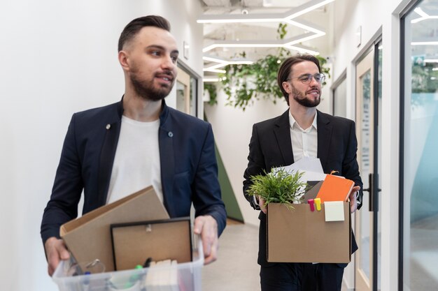 Medium shot men carrying box