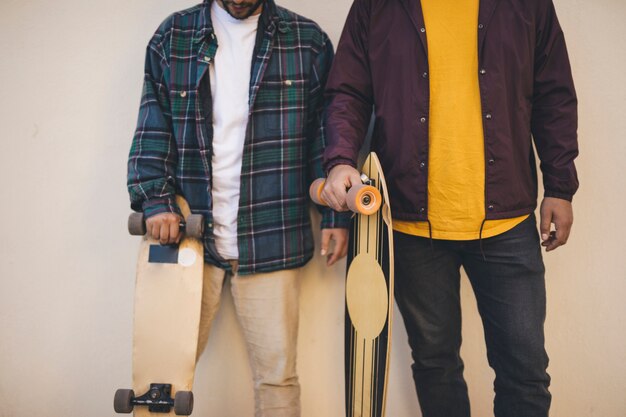 Medium shot of men holding skateboards