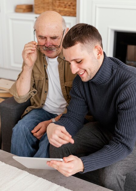 Medium shot men looking at tablet