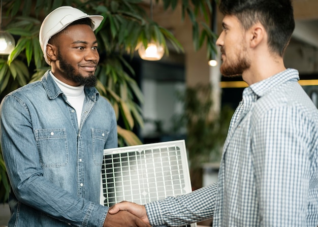 Medium shot men shaking hands