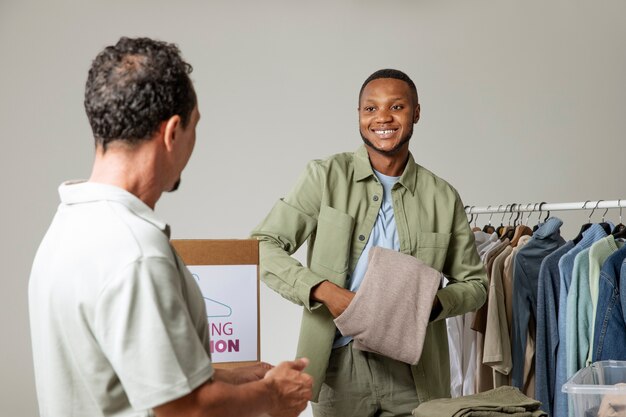 Medium shot men with clothing donations