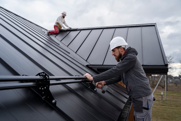 Medium shot men working on roof together