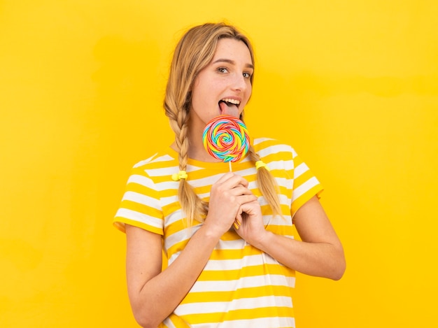 Medium shot model eating lollipop