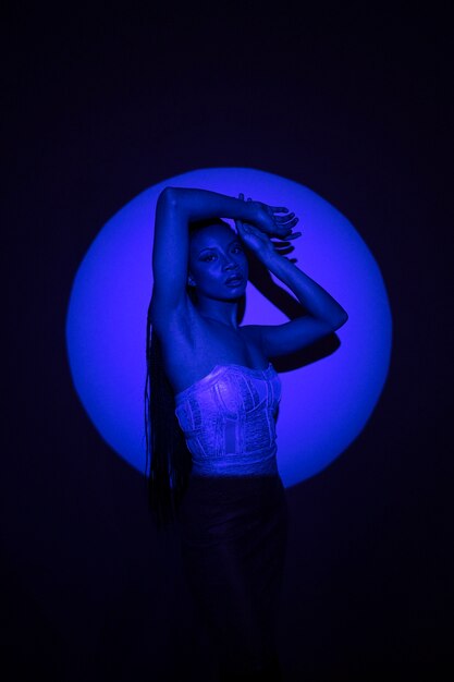Medium shot model posing in blue light