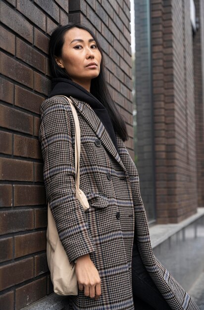 Medium shot model posing near wall