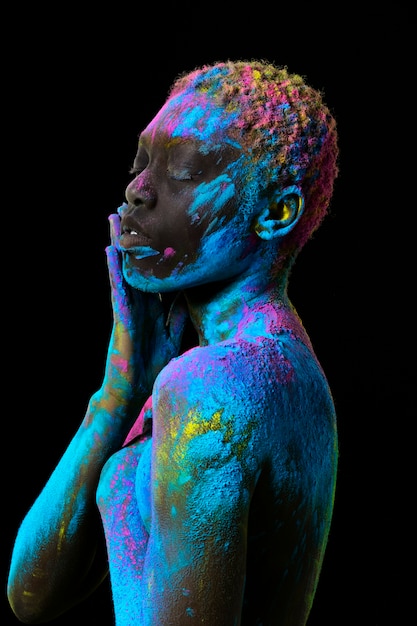 Medium shot model posing with colorful powder