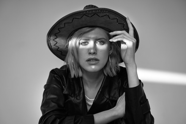 Medium shot model posing with hat black and white