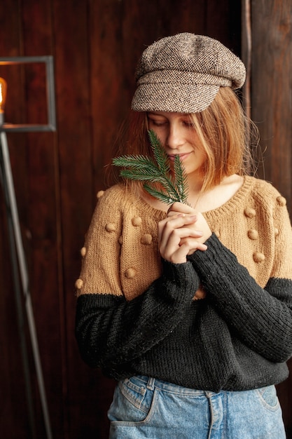 Medium shot model with fir tree twig and hat