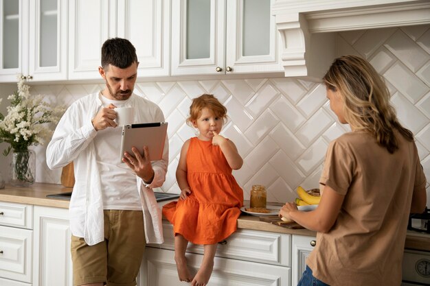 Medium shot modern family with tablet