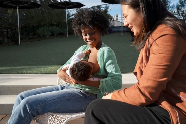 Medium shot mother breastfeeding baby