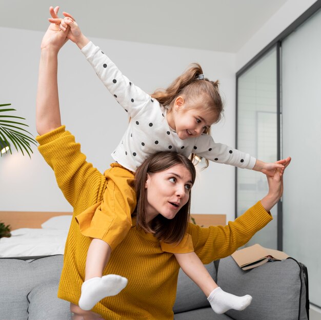 Medium shot mother and girl indoors