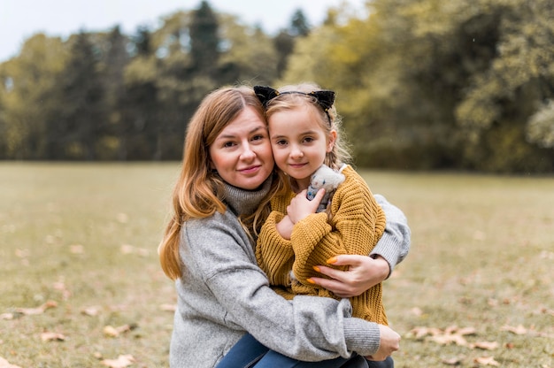 Medium shot mother and girl posing