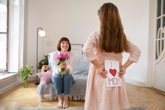 Medium shot mother and girl with gifts