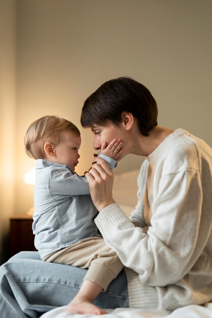 Medium shot mother holding baby