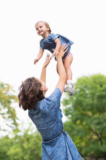 Free photo medium shot of mother holding her daughter