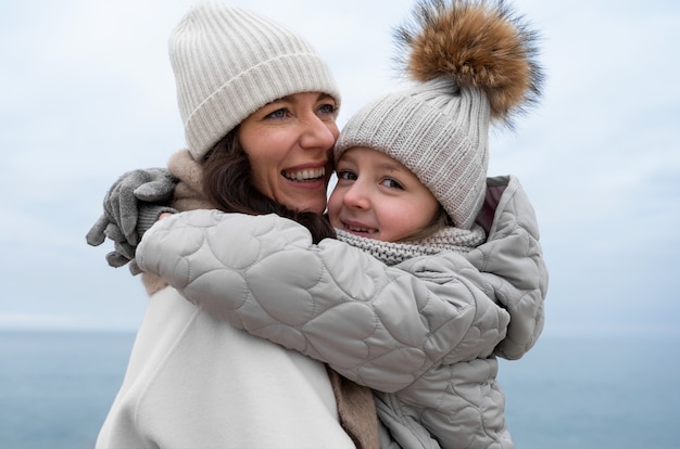 Free photo medium shot mother and kid at beach