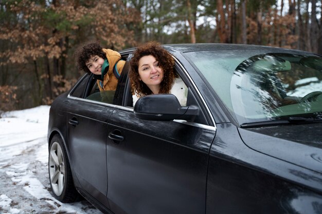 Medium shot mother and kid in car