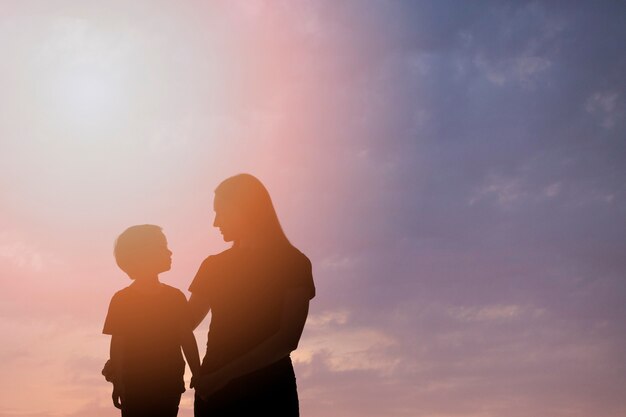 Medium shot mother and kid silhouettes