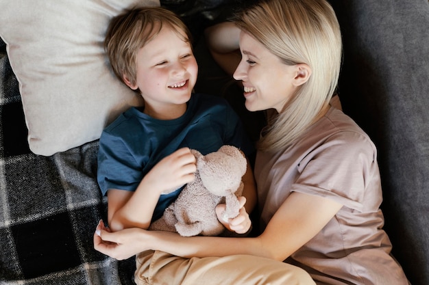 Medium shot mother and kid with toy