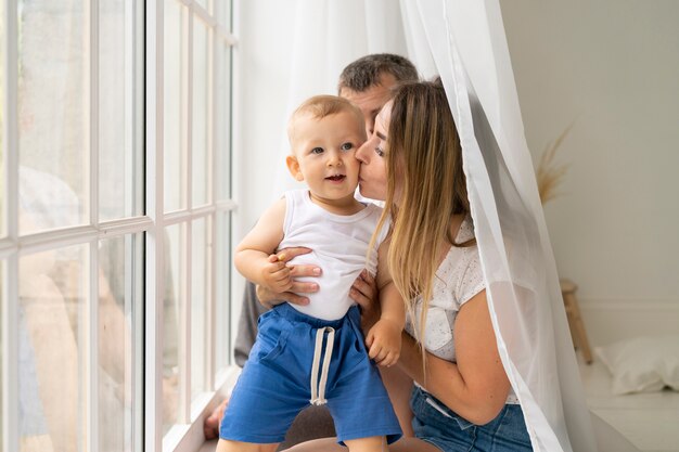 Medium shot mother kissing her son