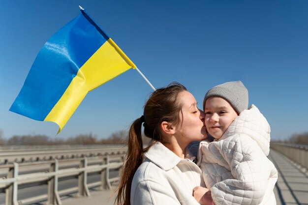 Medium shot mother kissing little kid