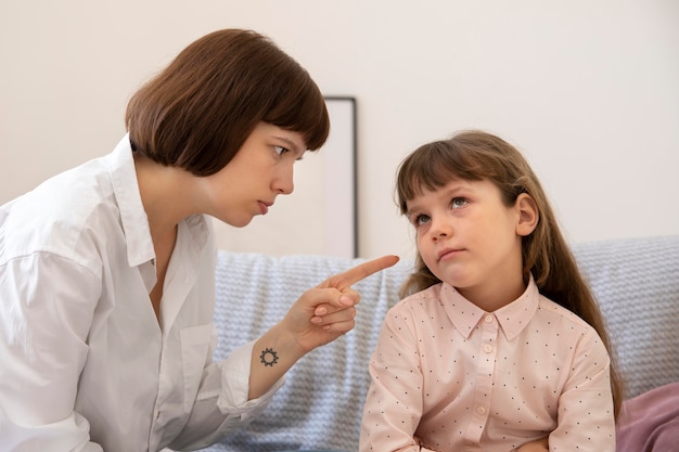 Medium shot mother scolding daughter