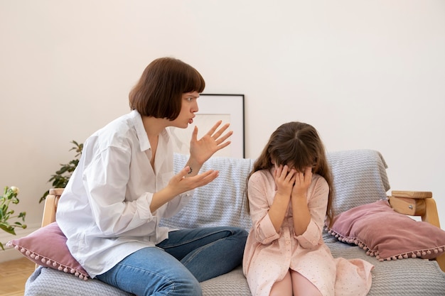 Medium shot mother scolding daughter