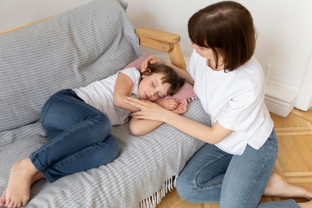 Medium shot mother sitting near daughter