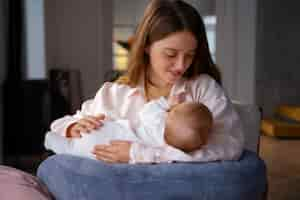 Free photo medium shot mother with cute newborn