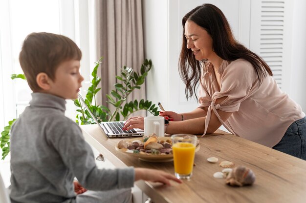 Medium shot mother working at home