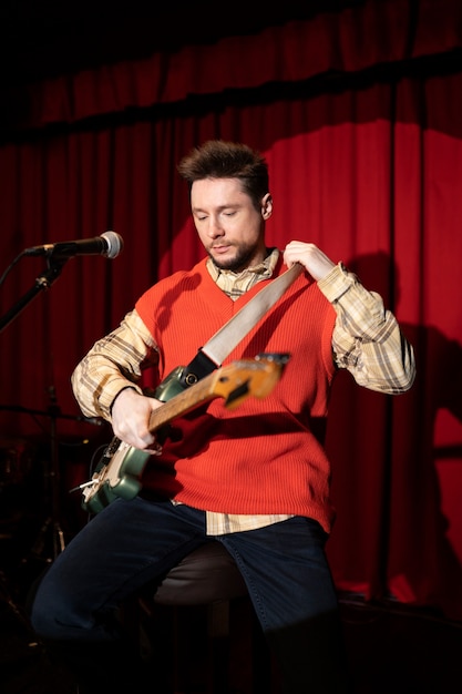 Medium shot musician holding guitar