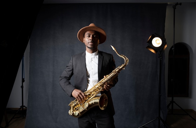 Medium shot musician holding saxophone