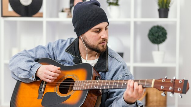 Medium shot musician wearing earphones