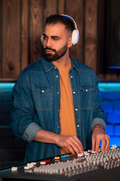 Medium shot musician wearing headphones