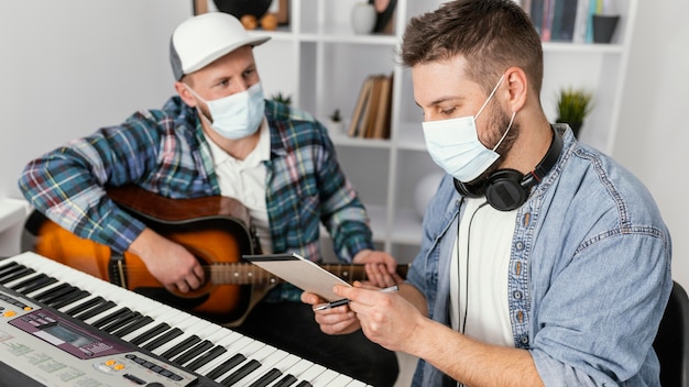 Medium shot musicians wearing protective masks