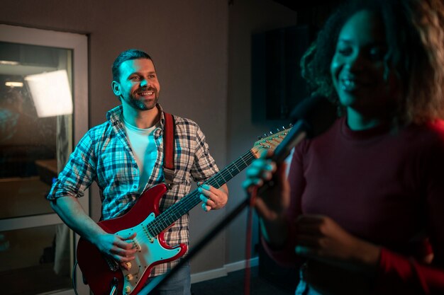 Medium shot musicians working in studio