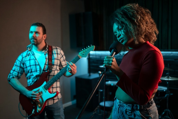 Medium shot musicians working in studio