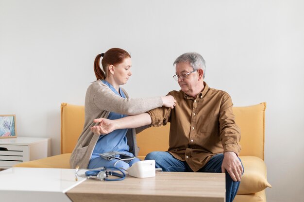 Medium shot nurse checking man