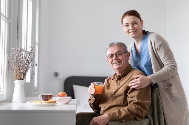 Medium shot nurse and man posing