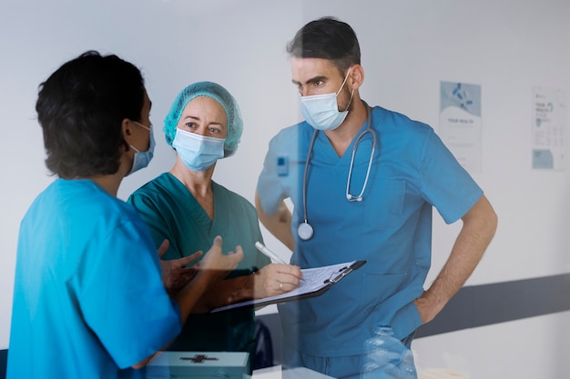 Medium shot nurses wearing face masks