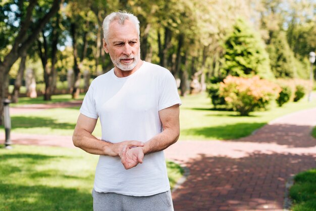 Medium shot old man measuring his pulse