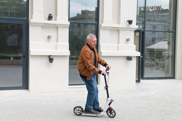 Medium shot old man on scooter