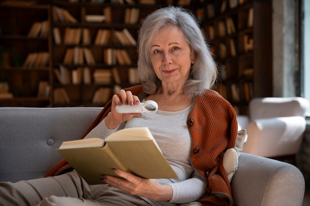 Free photo medium shot old woman in library