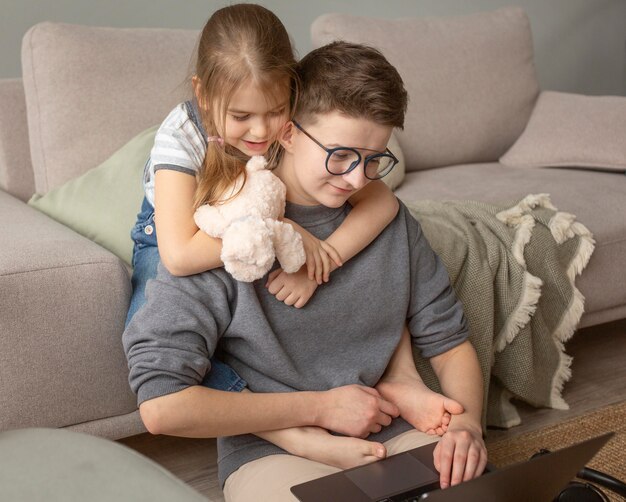 Medium shot parent working at home with kid