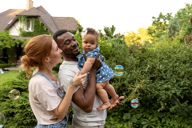 Medium shot parents holding baby