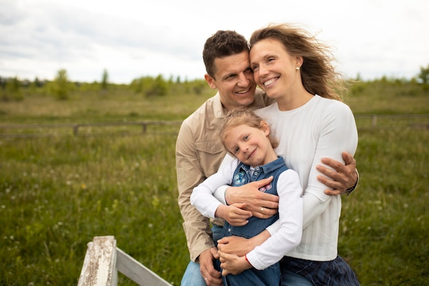 Free photo medium shot parents with kid outside