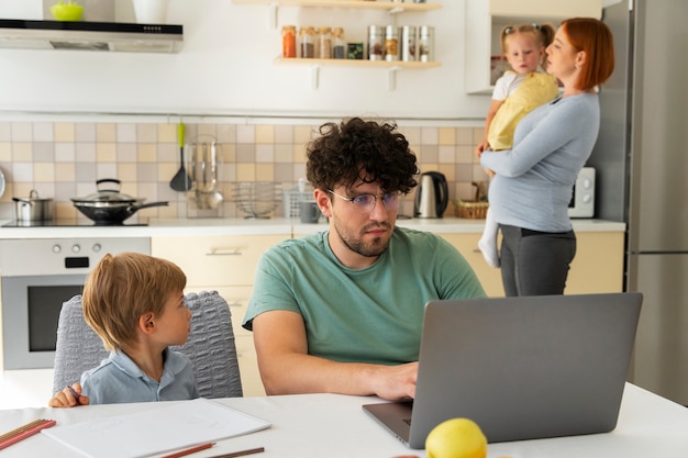 Medium shot parents working from home