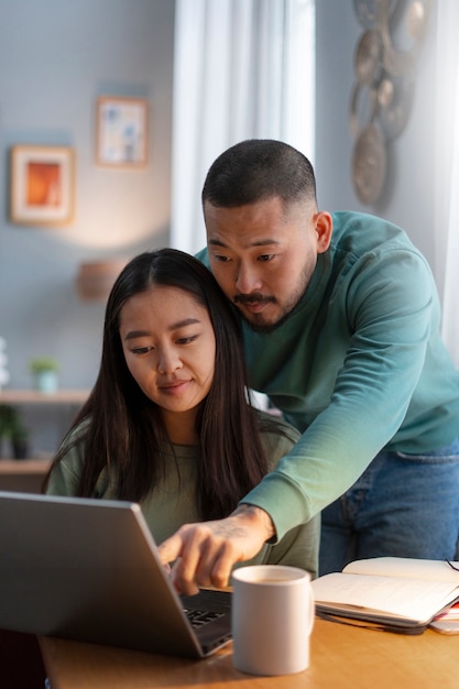 Medium shot parents working from home