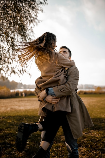 Medium shot partners hugging outdoors