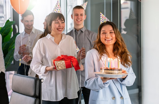 Free photo medium shot people celebrating with cake